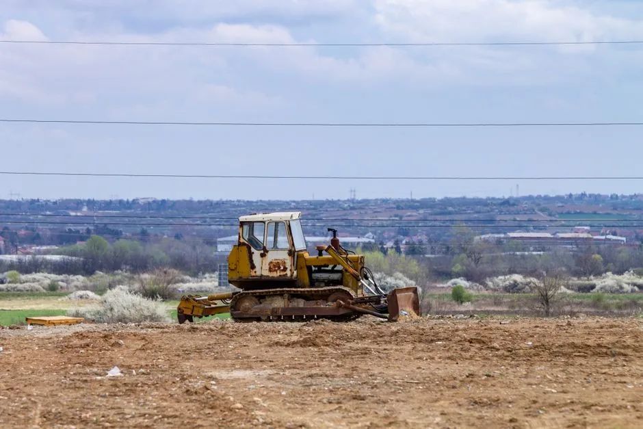 Freshly graded land with earthmoving equipment